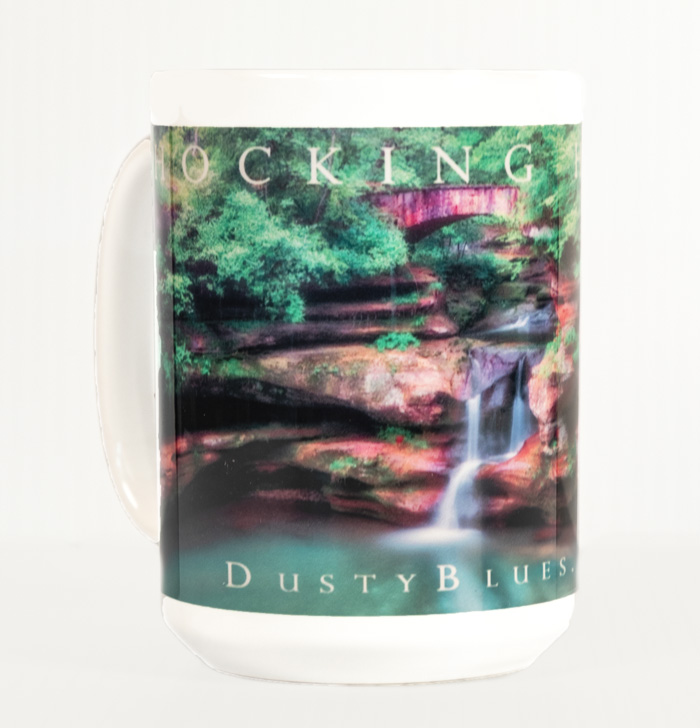 The DustyBlues Hefty 15 Oz. Coffee Mug adorned with our classic Upper Falls at Old Mans Cave. Available online or in our convenient...