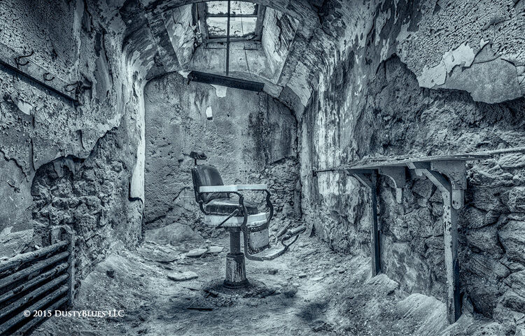 The old barber chair sis waiting still in a long ago decayed prison.